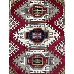 Indo Caucasian rug, red ground field with three medallions, all over geometric design 
