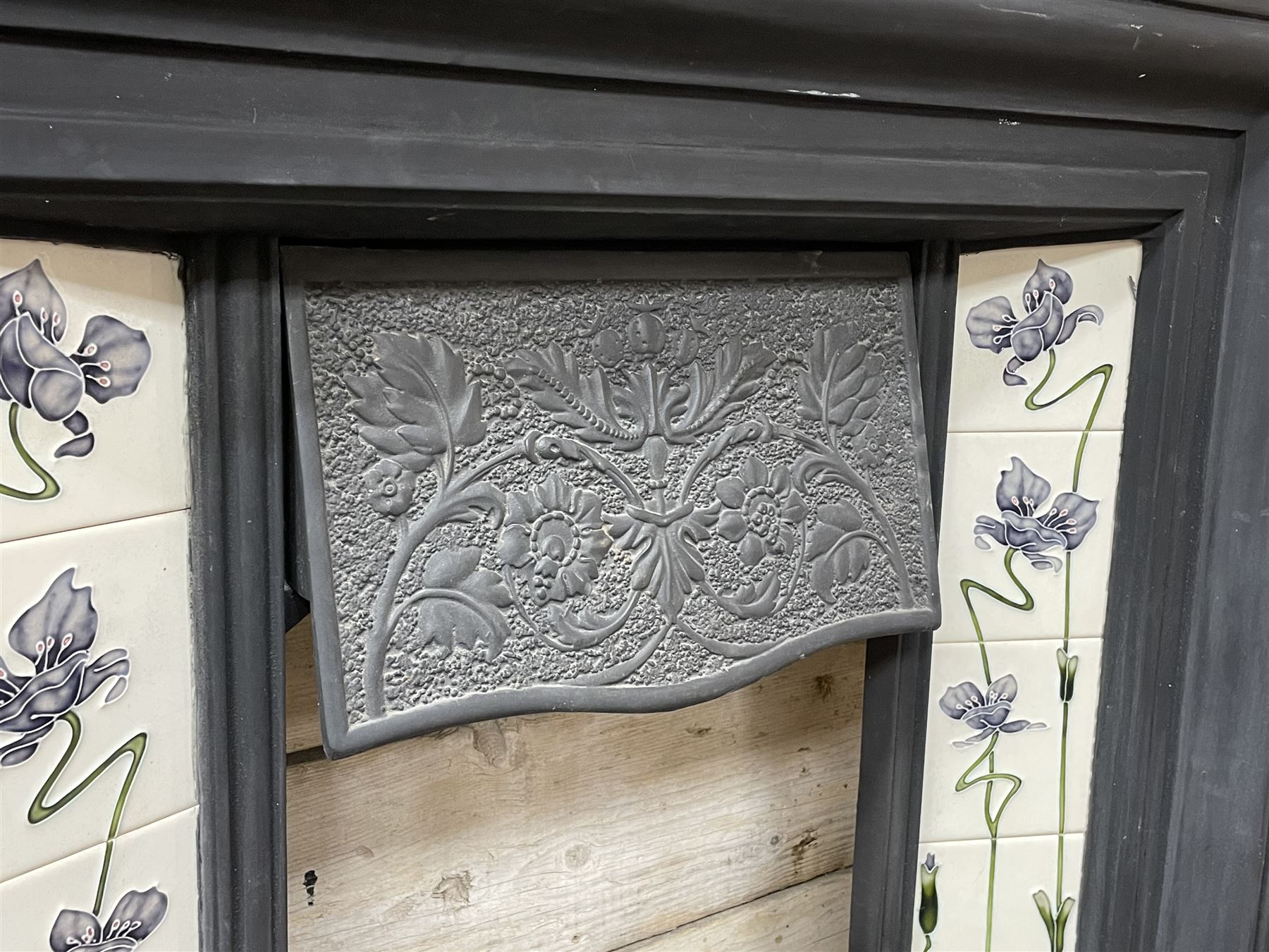 The Gallery Collection Fireplaces - 'Edwardian' cast iron fireplace, the hood decorated with interlacing floral design, with Art Nouveau inspired upright tiles