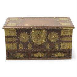 Early 20th century brass-mounted hardwood chest, the hinged top and front richly decorated with applied and studded brass panels and pierced lock escutcheon, revealing a candle box, reinforced with brass corner mounts