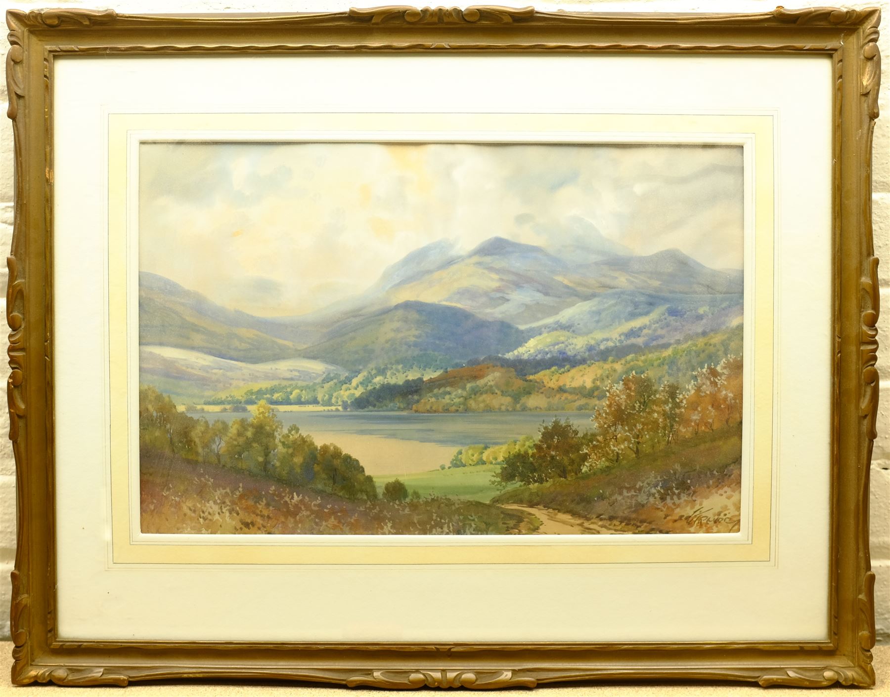 George Trevor (British fl.1920-1940): Loch with Mountains Beyond, watercolour signed 35cm x 53cm