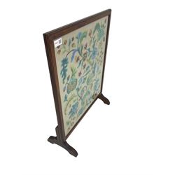 Late 20th century beech framed fire screen, with floral needle work panel