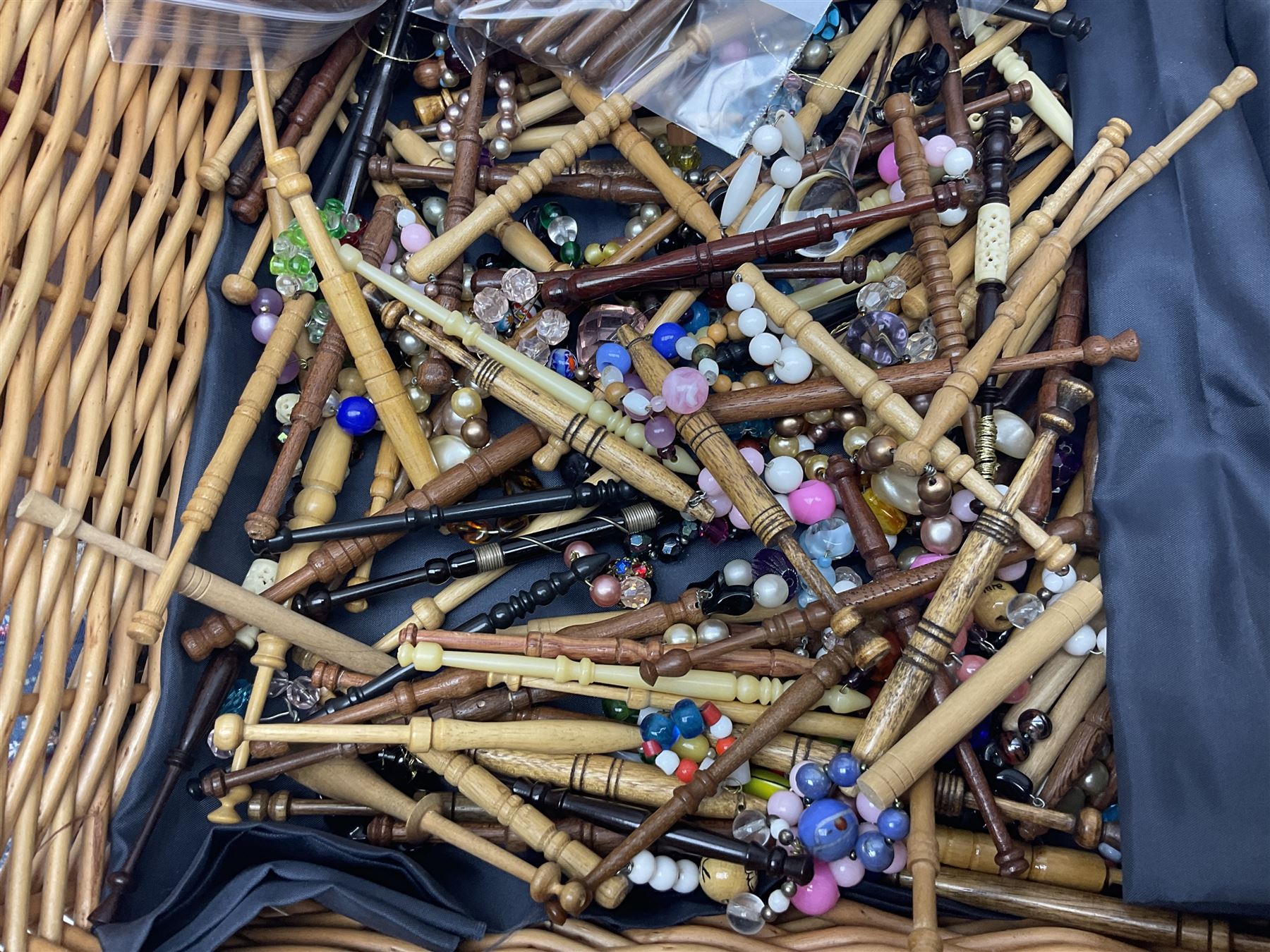 Collection of lace making wooden bobbins, together with lace making books and a handmade storage box