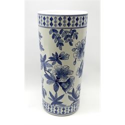A blue and white umbrella stand, decorated with central band of flowers within geometric borders, H45cm. 