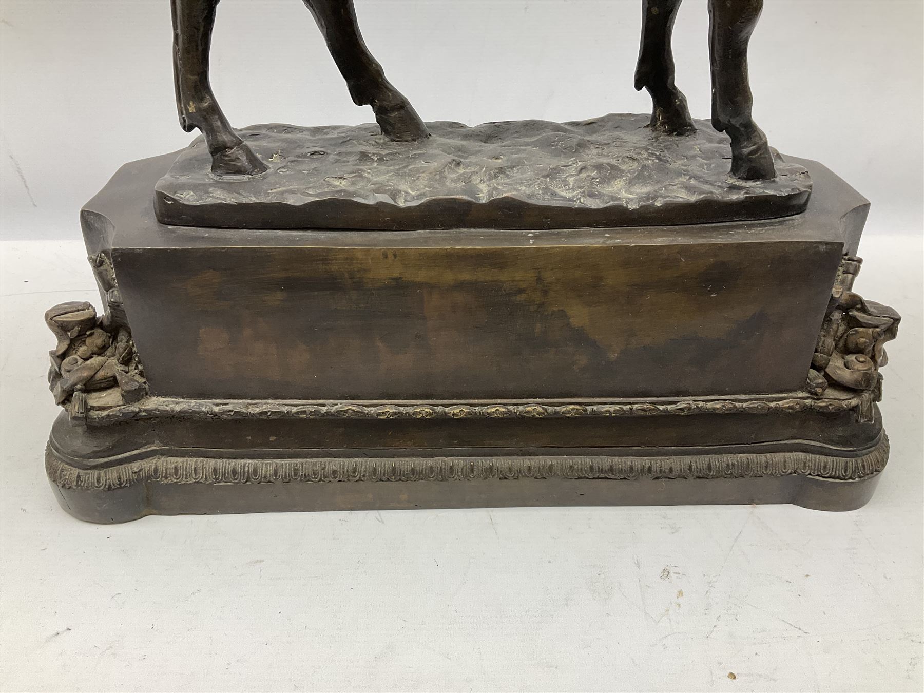 Large and impressive bronze figure of Wellington seated on a horse, on a sarcophogus shaped stepped base impressed 'Meunier Paris', the canted corners inset with battle trophies H68cm L50cm D22cm