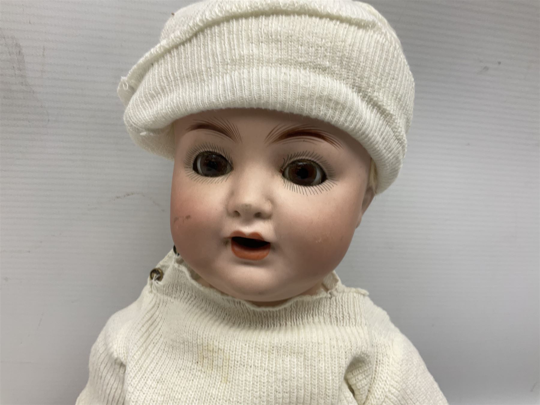 Carl Harmus Germany bisque head doll with applied hair, sleeping eyes, open mouth with teeth and composition body with jointed limbs; marked 'Harmus 313.4/0 Germany' H38cm; and Alt, Beck & Gottschalk Germany bisque head doll with applied hair, fixed eyes, open mouth with tongue and composition body with jointed limbs H44cm (2)