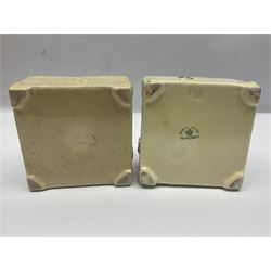 Four square honey boxes with lids,  each decorated with honeycomb pattern and finished with a bee finial