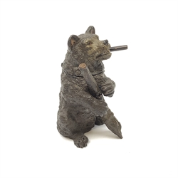 A bronze match holder or vesta, modelled in the form of a bear holding a stick and smoking a cigar, with cold painted detail, impressed beneath Bergm, H7.5cm. 