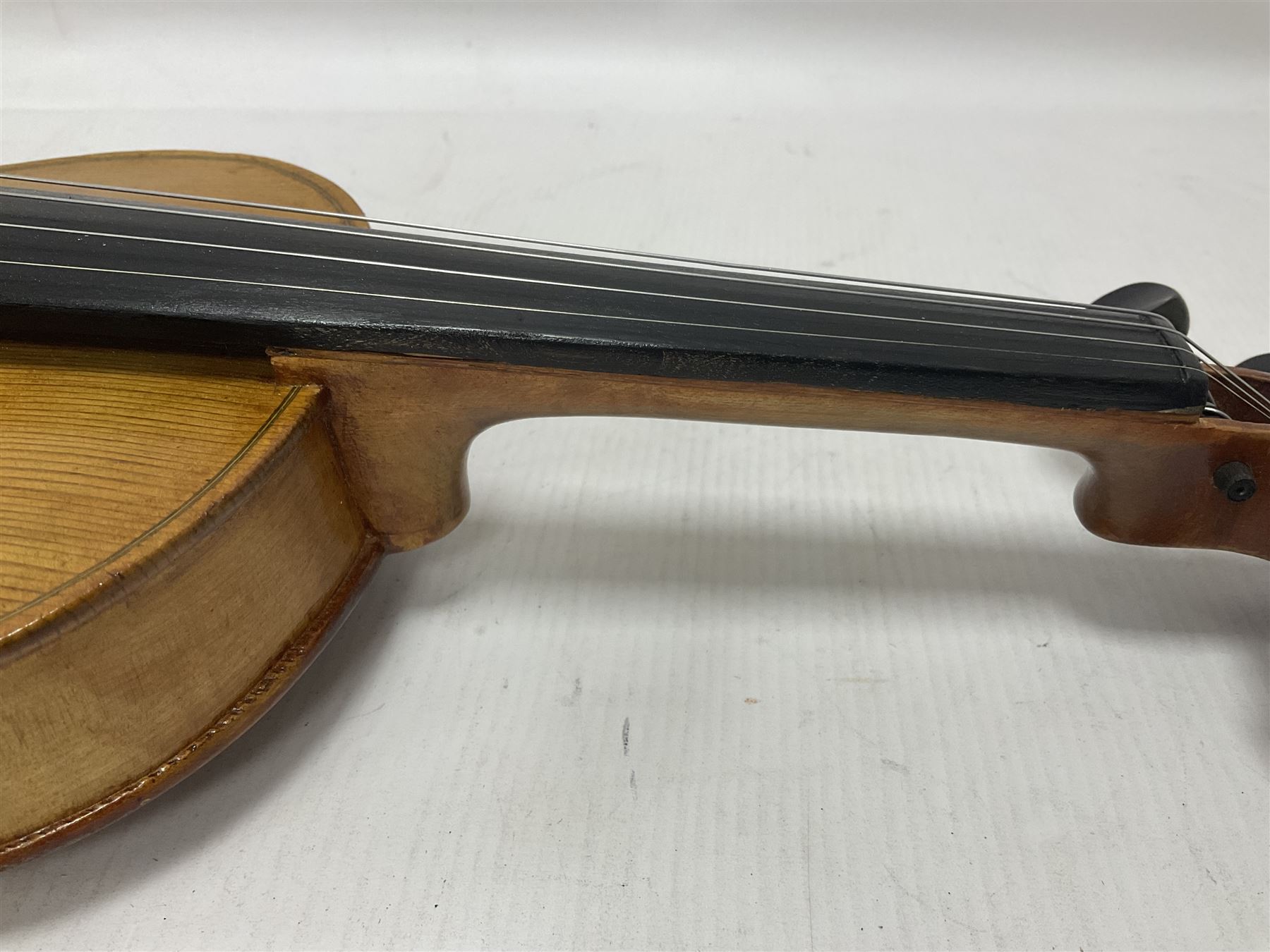 Copy of a full size Stradivarius violin, with an ebonised fingerboard, tailpiece and tuning pegs Length 60cm