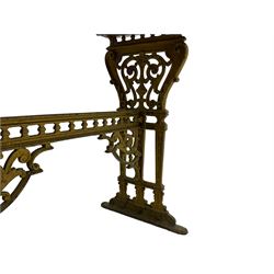 Pair of 19th century cast iron entrance tables, rectangular marble top over ornate gilt bases with scrolling foliate design and sledge feet, united by balustrade stretcher with scroll spandrels