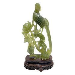 Carved jade figure of a phoenix perched on a flowering branch, upon a wooden stand, with original box, H27cm