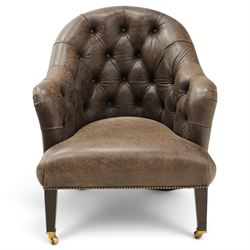 Georgian design tub-shaped club armchair, upholstered in back-buttoned dark tan leather with sprung seat, raised on square tapering supports with brass cups and castors