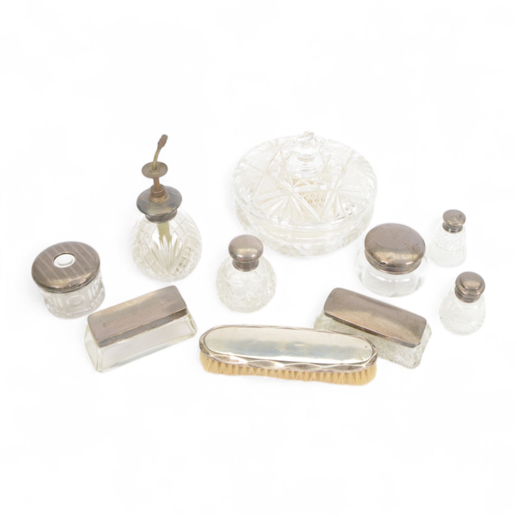 Collection of silver topped cut glass dressing table jars, together with a silver plated perfume bottle and large cut glass jar and cover