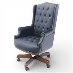 Chesterfield style desk chair upholstered in black, brass studded trim with tall button backed seat, with faux wooden base raised upon castors