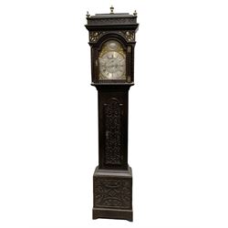 Edward Golland of Retford (Notts) - mid-18th century 8-day carved oak longcase c1760 , with a stepped caddy top and blind fret, break arch hood door flanked by carved pilasters with brass capitals,  trunk with a carved break arch toped door on a carved plinth with applied skirting and feet, brass dial with matching steel hands, silvered and engraved dial centre and chapter ring, with seconds dial and calendar aperture, four seasons spandrels and boss to the arch with makers name, four pillar rack striking movement, striking the hours on a bell. With weights and pendulum.            
Edward Golland is recorded as working in Retford during the late 18th century.