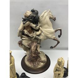 Composite figure of a couple upon a rearing horse, together with a collection of resin immortals and two bone chests 
