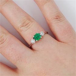 18ct white gold emerald and diamond three stone ring, single modified square cut emerald of approx 0.65 carat, with a round brilliant cut diamond set either side, hallmarked, total diamond weight approx 0.35 carat
