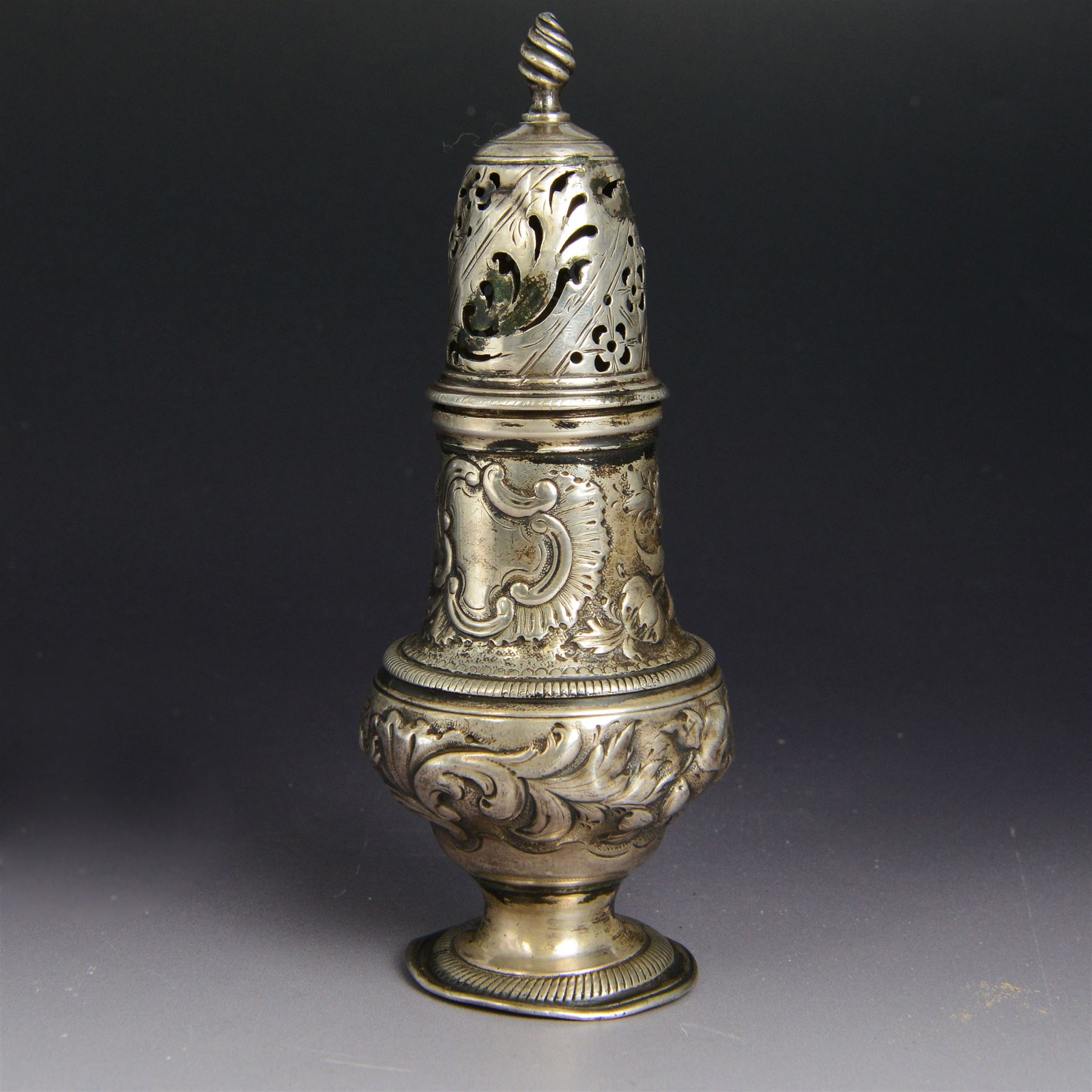 George III silver sugar caster, of typical form profusely embossed with floral and foliate details, hallmarked Jabez Daniell & James Mince, London 1768, H15cm