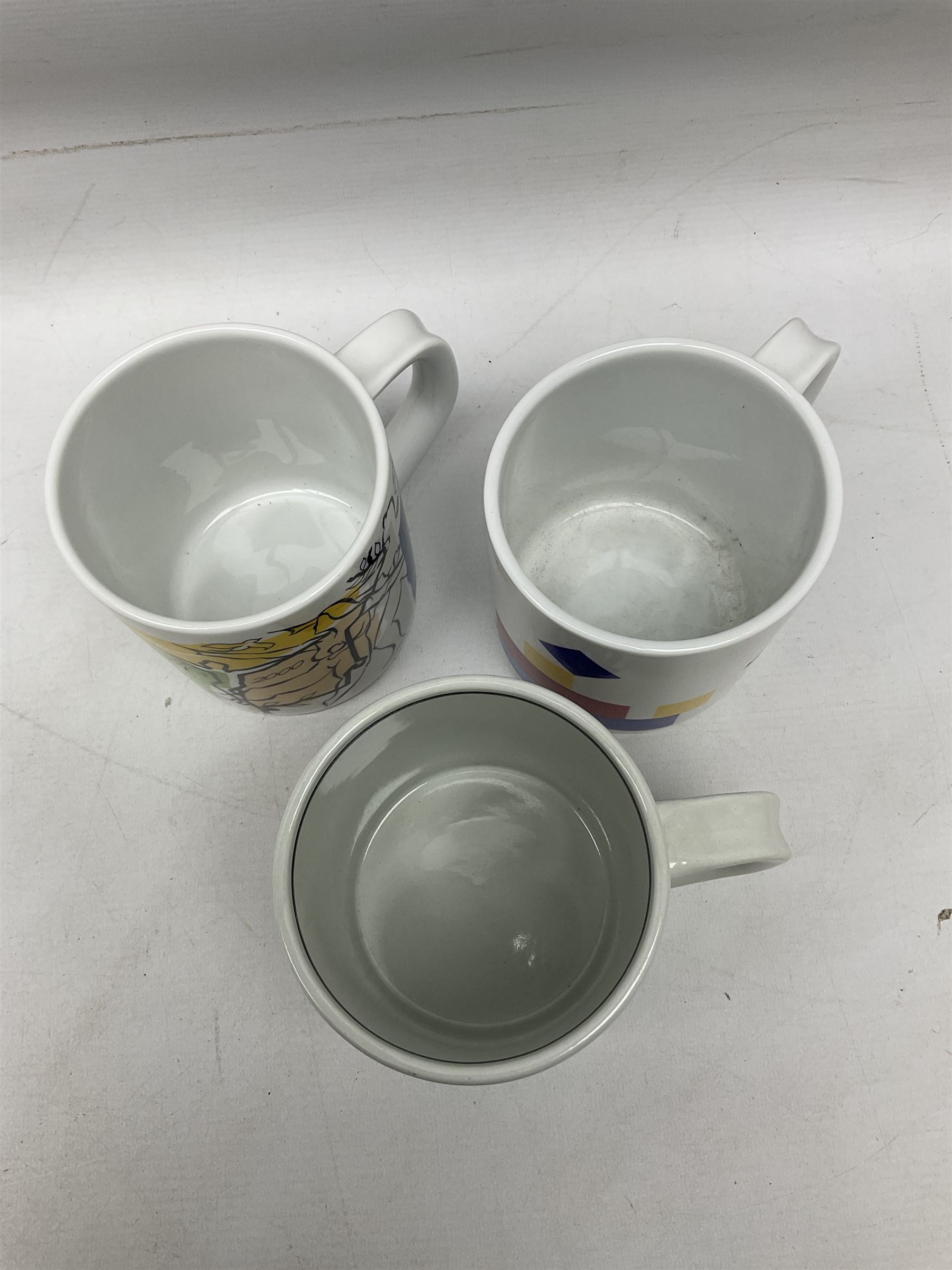 Set of three Royal Copenhagen year mugs, comprising 1976 with silver plaque stamped 925 beneath, and two 2000 examples, H11.5cm
