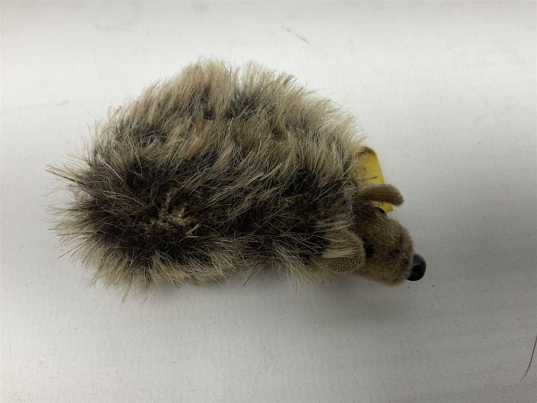 Group of Steiff figures, comprising Mikki and Mukki, circa 1950s no 7628/12 and 7627/12, with original tags, two hedgehogs no 1570/10, and another smaller 1670/03, small owl no 7480/06, and painted metal Steiff harlequin style bear