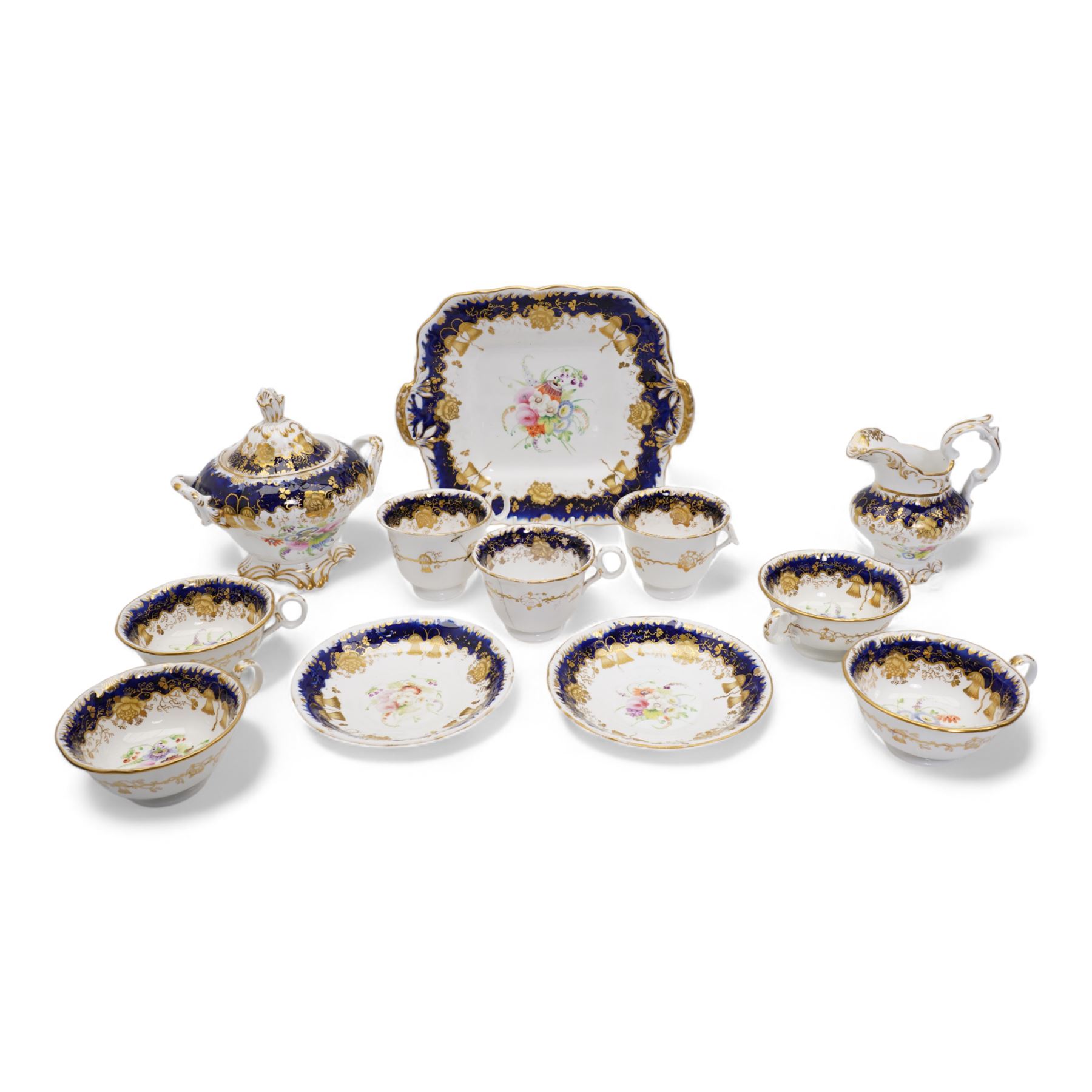 19th century porcelain part tea service, probably Spode, comprising sucrier, milk jug, sandwich plate, seven cups and two saucers, decorated with floral sprays, within cobalt blue and gilt borders, pattern no. 735 