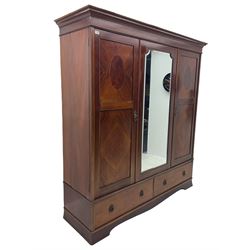 Edwardian inlaid mahogany triple wardrobe, fitted with centre bevelled mirror enclosed by two segmented veneered doors