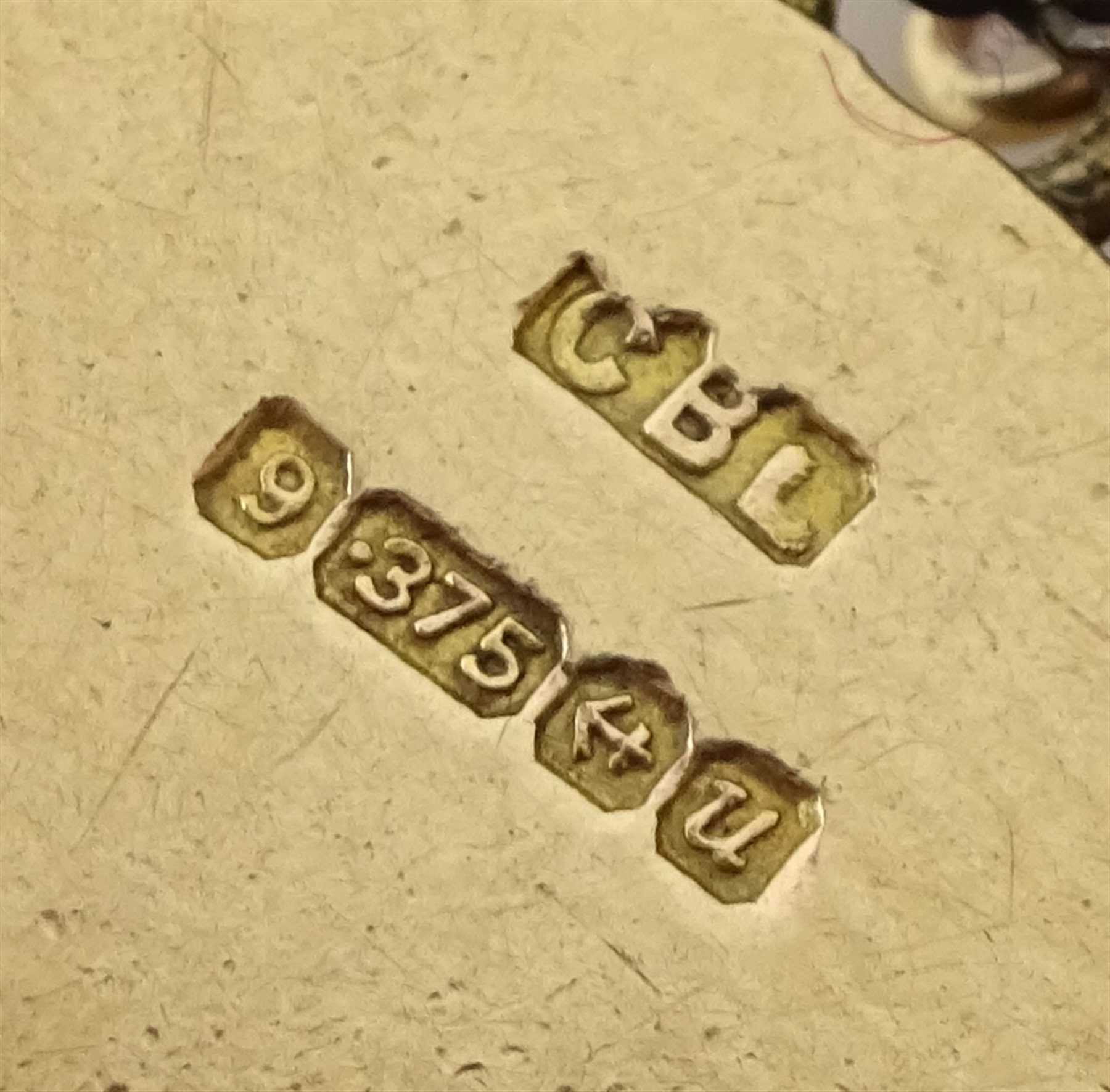 9ct gold curb bracelet with heart locket hallmarked,  with ten 9ct gold charms including stork carrying a baby, house, first aid box and an 18ct gold cross charm, all tested, hallmarked or stamped