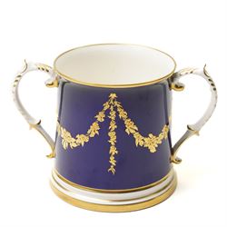 Lynton Porcelain Company loving cup, decorated with a British naval frigate, signed Stefan Nowacki, on a cobalt blue ground finely embellished in gilt enamel, printed marks to base, H11.5cm 