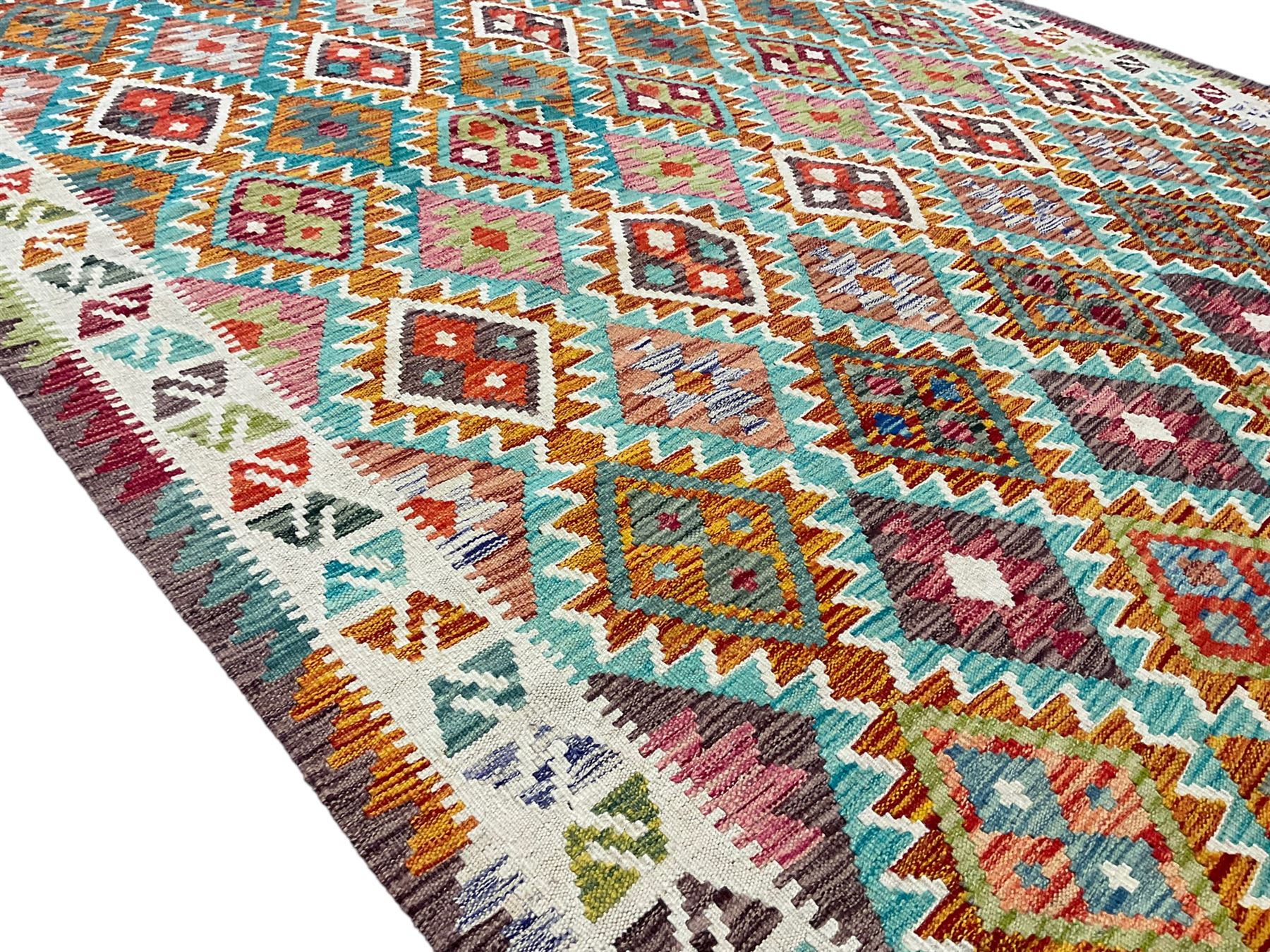 Anatolian Turkish Kilim multi-colour rug, decorated with all over lozenges in contrasting colours with ivory outline, the multi-band ivory border with repeating geometric shapes and small lozenges or diamonds
