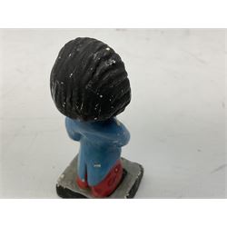 Robinson Jam plaster Golly band, including drummer and singer, H7.5cm

Originally handmade by mothers in Africa for their children from old fabric and cloth, the golly doll was adopted as the mascot and trademark for the Robertson's confectionery brand around 1910 after the company's founder John Robertson visited the US and noticed children playing with them. Robertson's Gollies have been collected by people across the UK and around the world for generations but garnered a contentious image in the 1980s because of links to racism. The trademark was removed from Robertson's branding in 2001.