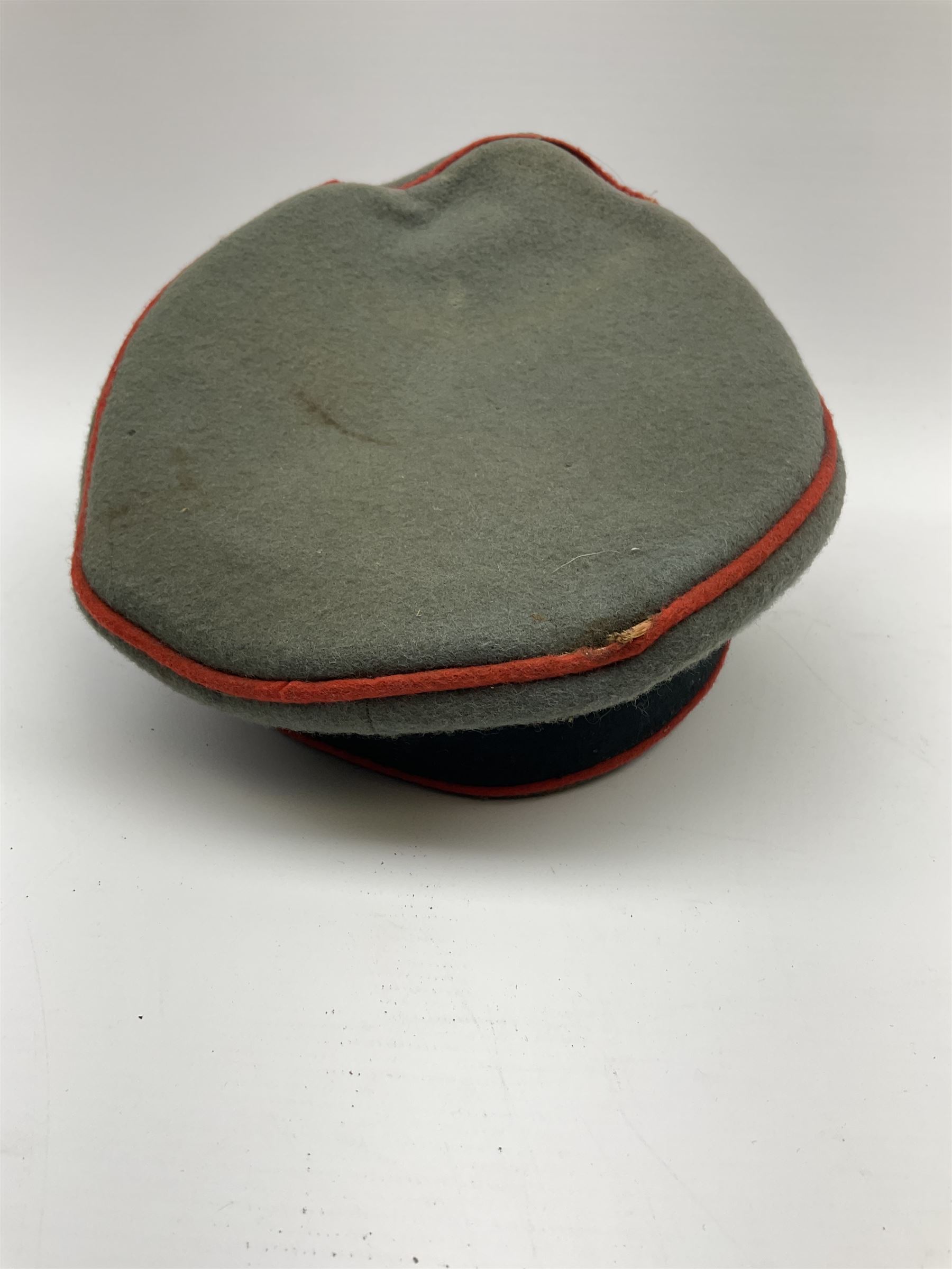 WW2 German Army Artillery officer's peaked cap, red piping to the crown and bordering the central band, zinc eagle and aluminium cockade insignia, officer's bullion chin cords, interior retains original sweatband and lining has tailor's celluloid diamond with 'Extra Klasse' logo and 'Marke Standard'