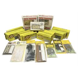 '00' gauge trackside accessories - twenty-six Ratio Plastic Model kits of passenger coaches, wagons, signals, water tower, signal box, station building and platform canopy; and four Ian Kirk passenger coach/wagon kits etc; all boxed or packaged