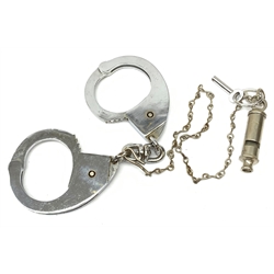 Pair of 1960's Hiatt chromium plated handcuffs with key and a 'Metropolitan' whistle
