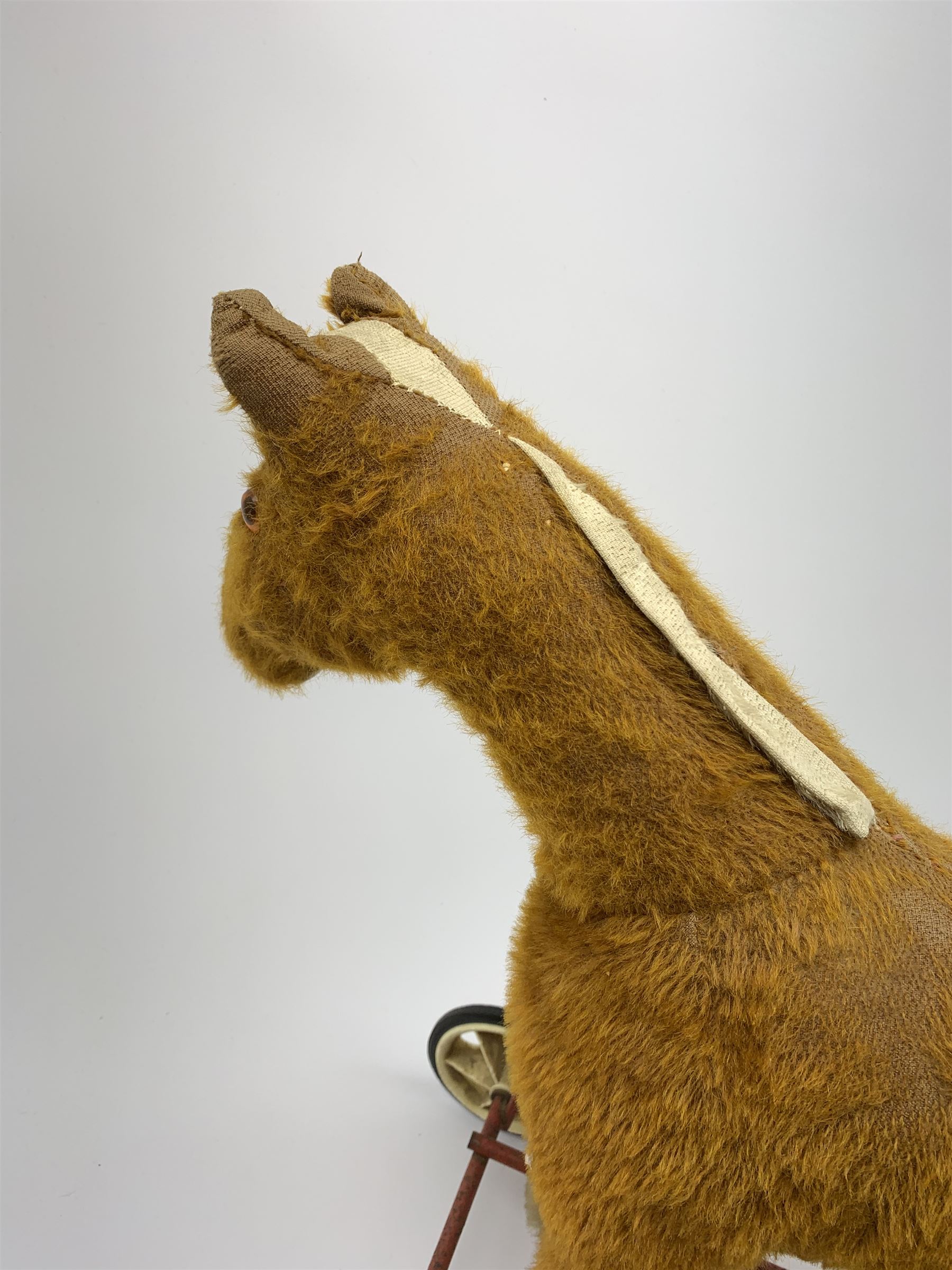 Pedigree push along plush covered horse 1950s-60s with red tubular metal framework and beech foot rests H25