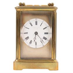 Brass carriage clock, engine turned masked dial with beveled glass sides, together with another clock 
