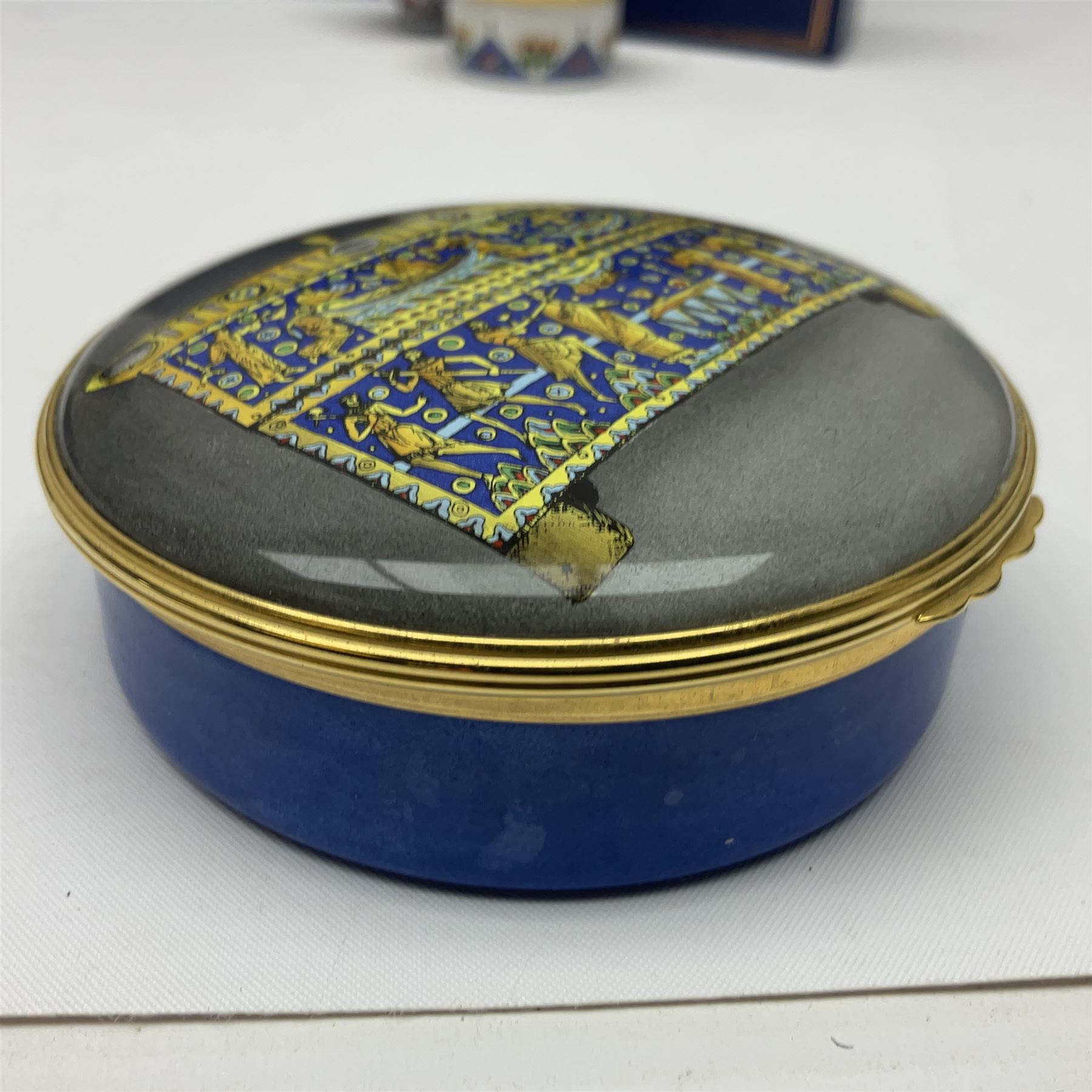 Halcyon Days bonbonniere, modelled as pink roses in a planter painted with a blue and white Japanese scene, together with five Halcyon Days enamel boxes, one a larger example depicting 'The Becket Casket' and four smaller boxes, including The 1993 Easter Egg, Happy Birthday and Statue of Liberty examples, all boxed, Becket Casket D8cm