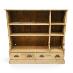 Late Victorian stripped pitch pine open bookcase, fitted with four adjustable open shelves, two drawers fitted to base with pull handles, on skirted base 