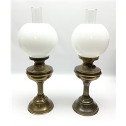 Two brassed oil lamps with glass shades and chimneys, in one box 