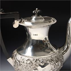 Late Victorian four piece silver tea set comprising teapot, coffee pot, sugar bowl and milk jug with embossed decoration, the cartouches engraved with an initial, the teapot and coffee pot Chester 1899 Maker George Nathan & Ridley Hayes, the sugar bowl and milk jug Birmingham 1899 Maker Thomas Hayes