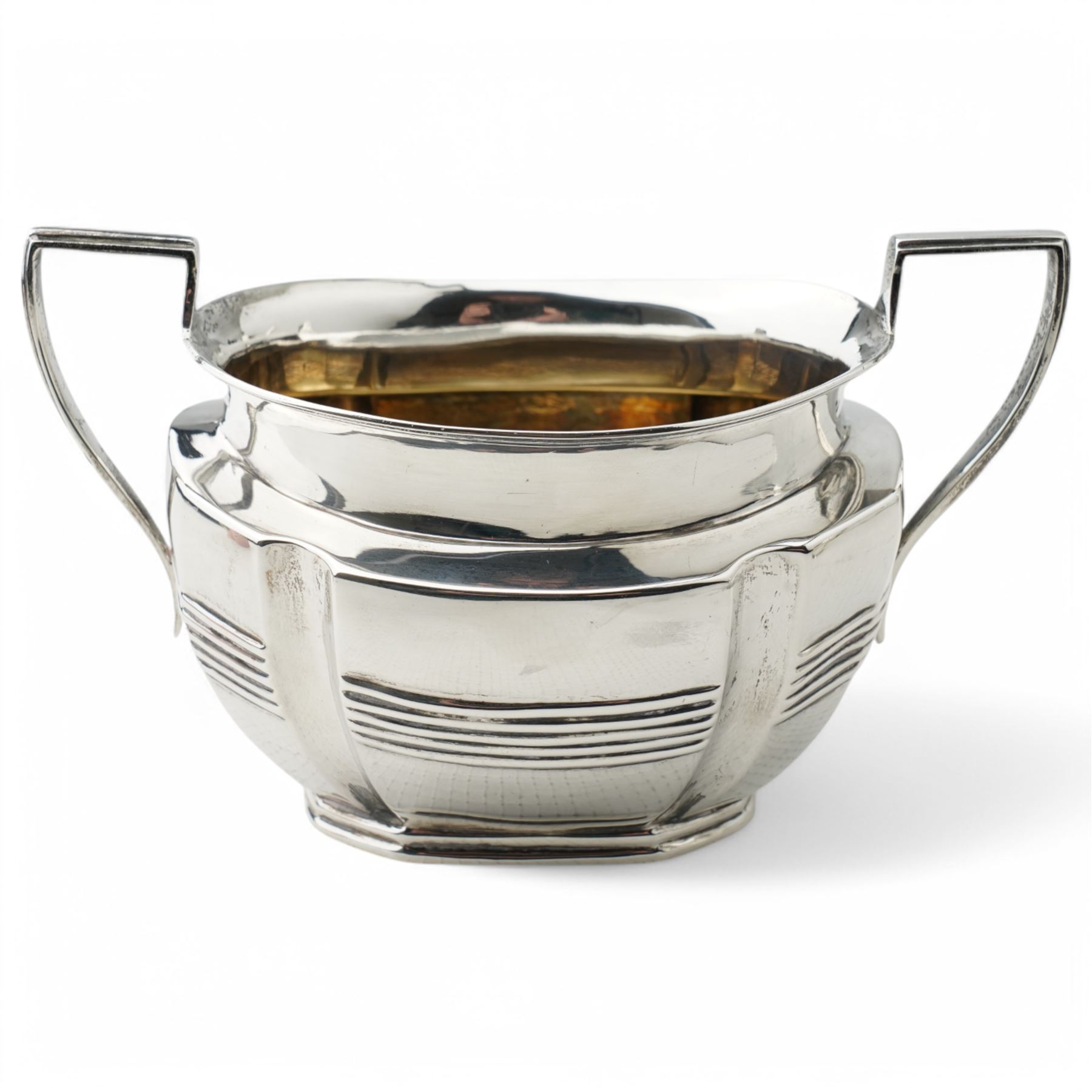 Late Victorian silver three piece tea set of panel sided oval design, the teapot with ebonised handle and lift, Chester 1898/99 Maker Florence Warden and William Aitken