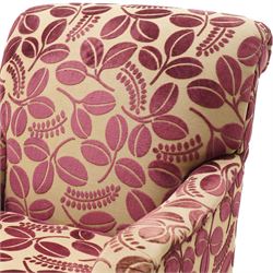 Traditional Howard shape armchair, rolled back and arms over deep seat, raised on turned supports with brass cups and castors, upholstered in plum foliate patterned fabric with loose seat cushion