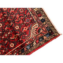 Persian crimson ground runner, the field decorated with Herati motifs,  three-band border, the main band decorated with repeating flowerheads 