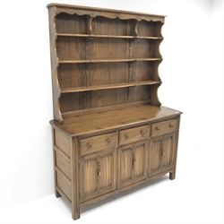 Ercol Old Colonial elm dresser, Golden Dawn finish, raised three tier plate rack above three drawers and three cupboards, stile supports, W147cm, H193cm, D52cm