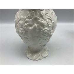 Pair of early/mid 19th century Copeland and Garrett white glazed pitchers, modelled in the Georgian style and moulded with the figures of Venus the Roman Goddess of Love, and Aurora the Roman Goddess of Dawn, within C scroll borders and foliate surround, the naturalistically modelled handle leading to a fruiting vine beneath the rim, upon a spreading base moulded with seashells, with printed green crowned wreath mark beneath, H20cm