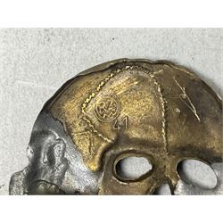 Two WW2 German 'SS' visor cap skull badges and another later; and visor cap eagle insignia (4)