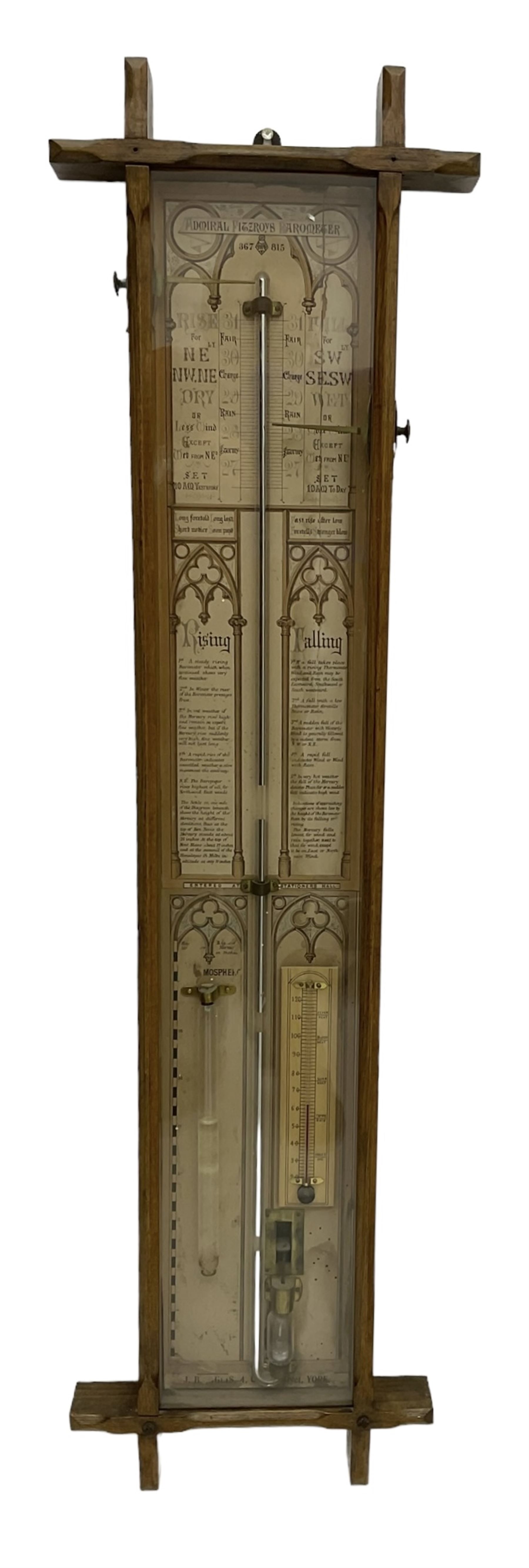 Admiral Fitzroy - Early 20th century Fitzroy barometer in a glazed gothic influenced oak case with chamfered uprights and top and base panels, full length paper scales with Fitzroy's observations and predictions, mercury bulb cistern, storm glass, spirit thermometer and brass sliding vernier pointers. Retailed by Inglis & Son, Coney Street, York.