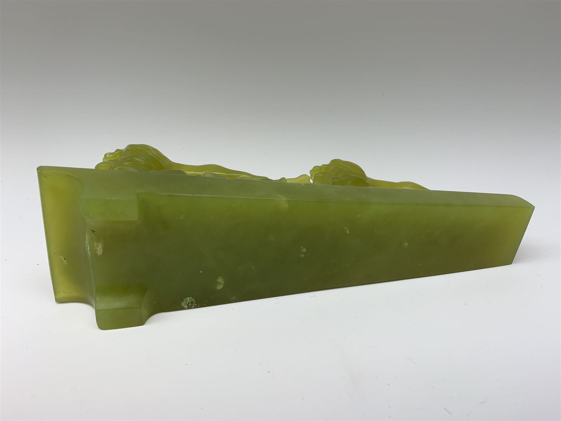 Green stone figural group depicting three lions, upon an inclined base, L21cm