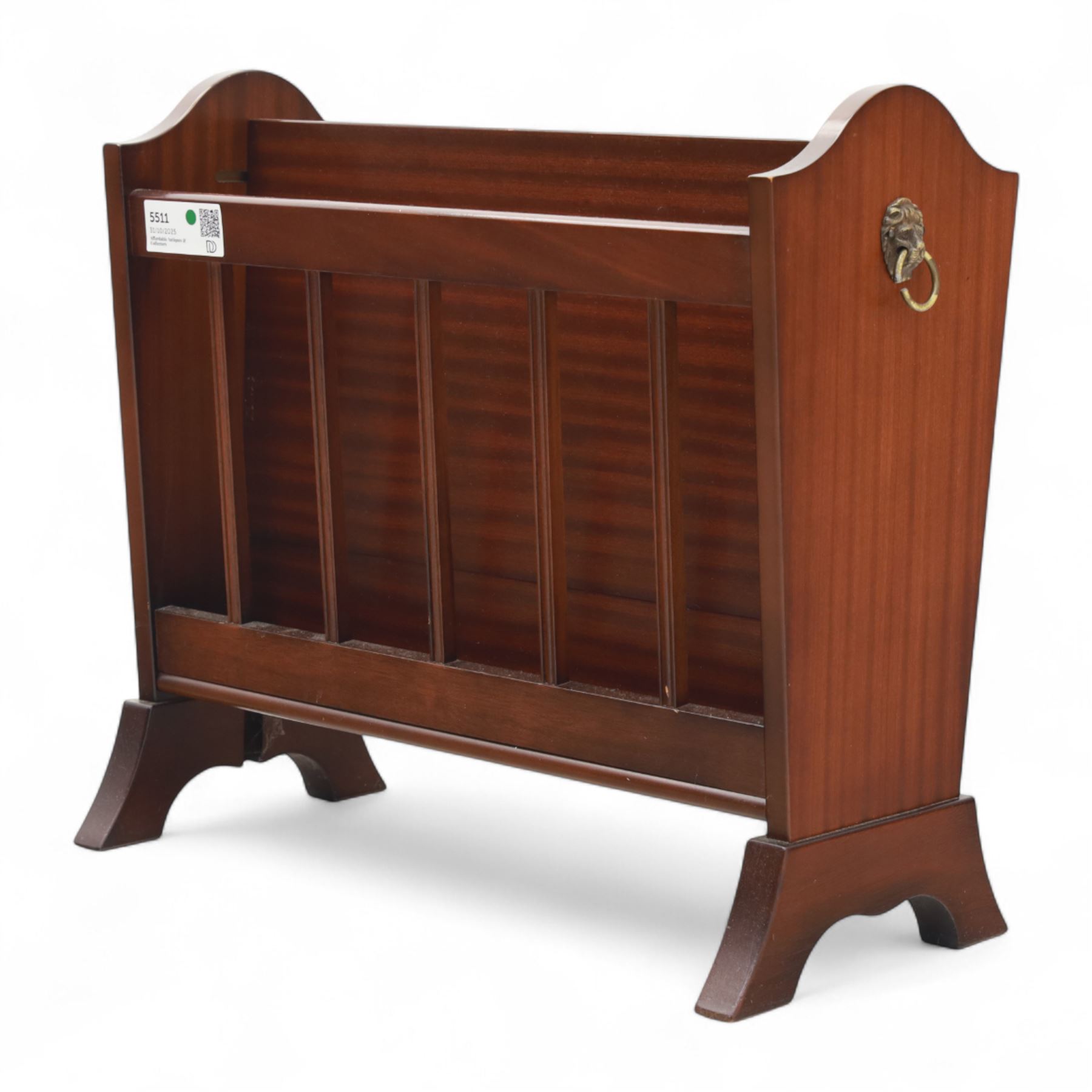 20th century mahogany magazine rack, with shaped ends and pierced divider slats, brass lion mask ring handles to each side, raised on splayed bracket feet
