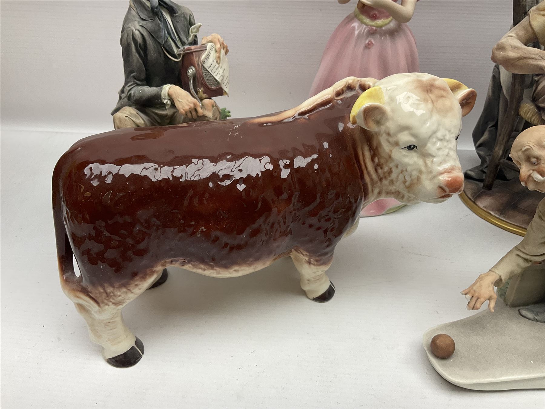 Two Capodimonte figures together with Melba Ware bull and other ceramics 