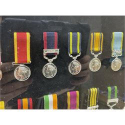 Limited edition large framed display board with sixty half-size copies of British Gallantry and Campaign Medals produced by Danbury Mint; all with ribbons and associated booklet