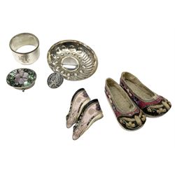 French silver plated wine taster of typical form, stamped, together with a silver plated napkin ring, and an 'Alpaca Silver' pill box with mother of pearl detailed cover, (3) together with Two pairs of late 19th/early 20th century Chinese Lotus shoes for binding feet, the first with purple silk heavily embroidered with ornate floral motifs, L10cm the second larger fuschia and black pair with thicker sole embroidered with flowers, L14cm